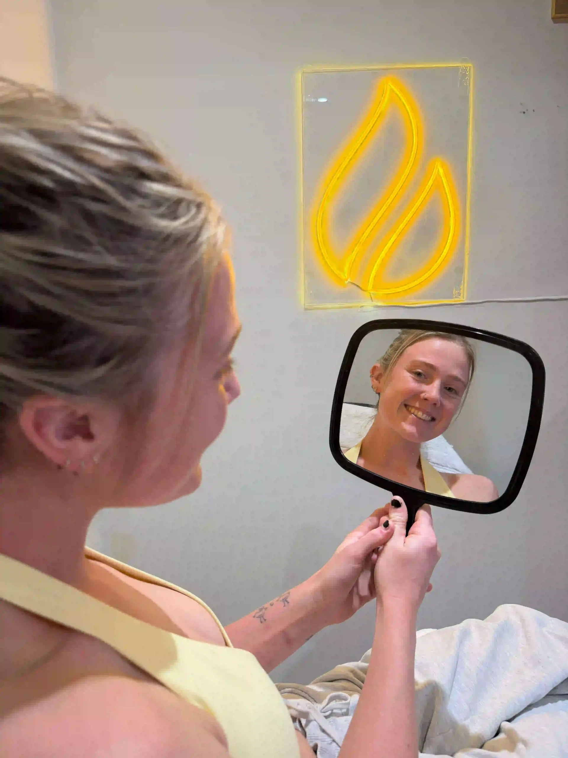 Staff model during an initial consultation mirror assessment at Core Aesthetics