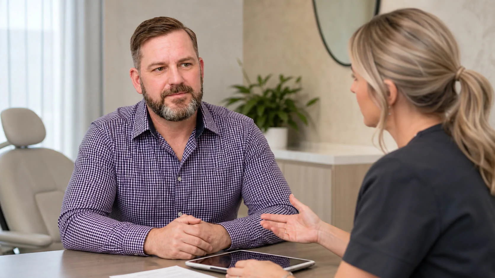 Corey Anderson RN reviewing facial change context with an adult patient in Oakleigh