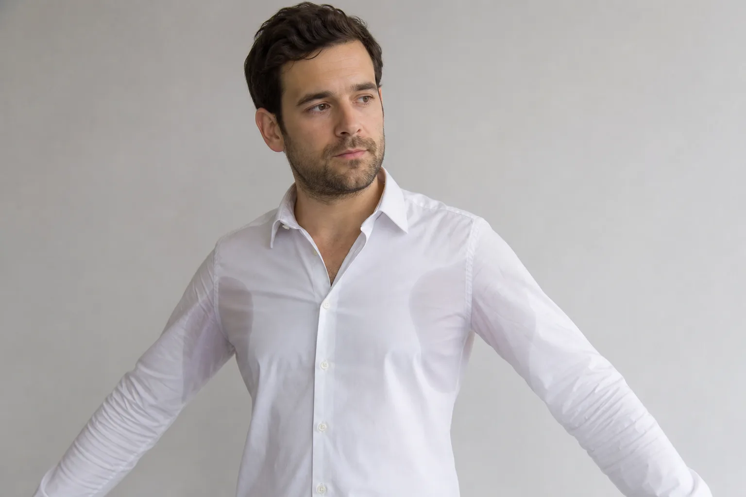 Adult man noticing underarm sweating before discussing the pattern with a clinician