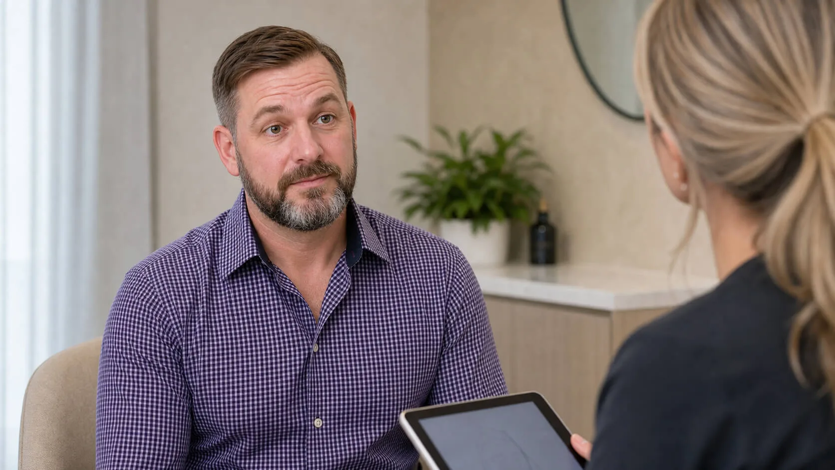 Corey Anderson RN and an adult patient discussing expression and appointment timing