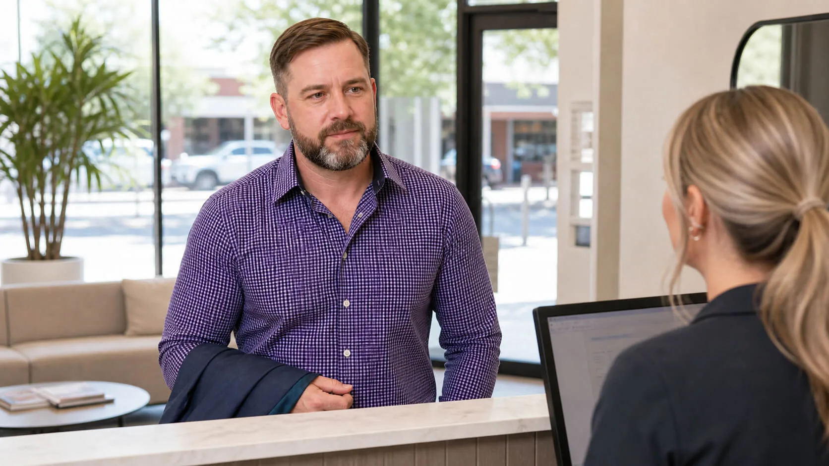 Adult arriving at a clinic reception desk for a consultation