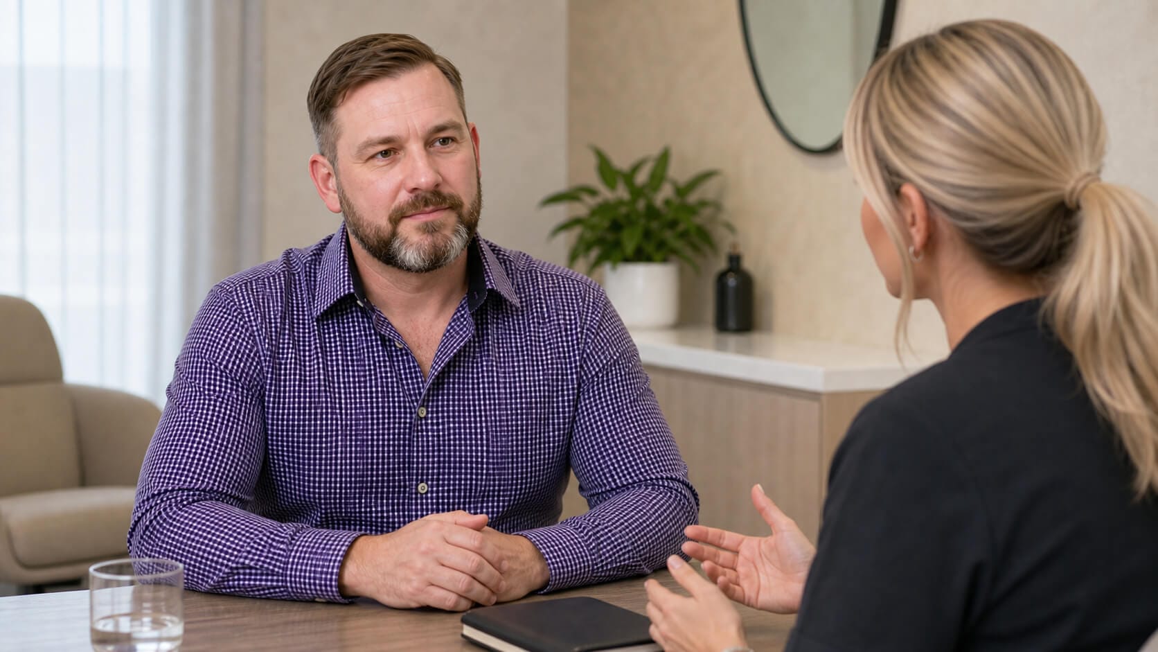 Adult patient and practitioner discussing the next stage after previous cosmetic care