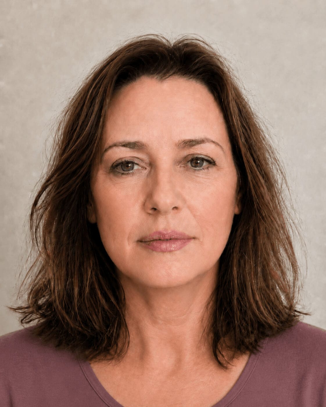 Adult woman in side profile supporting a jawline and lower face assessment discussion