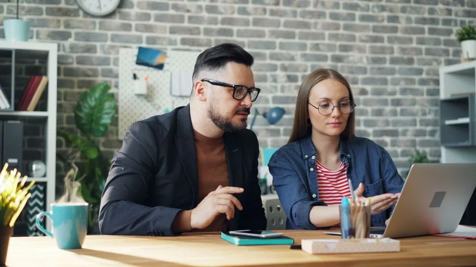 Private consultation discussion and paperwork review in a calm modern setting.