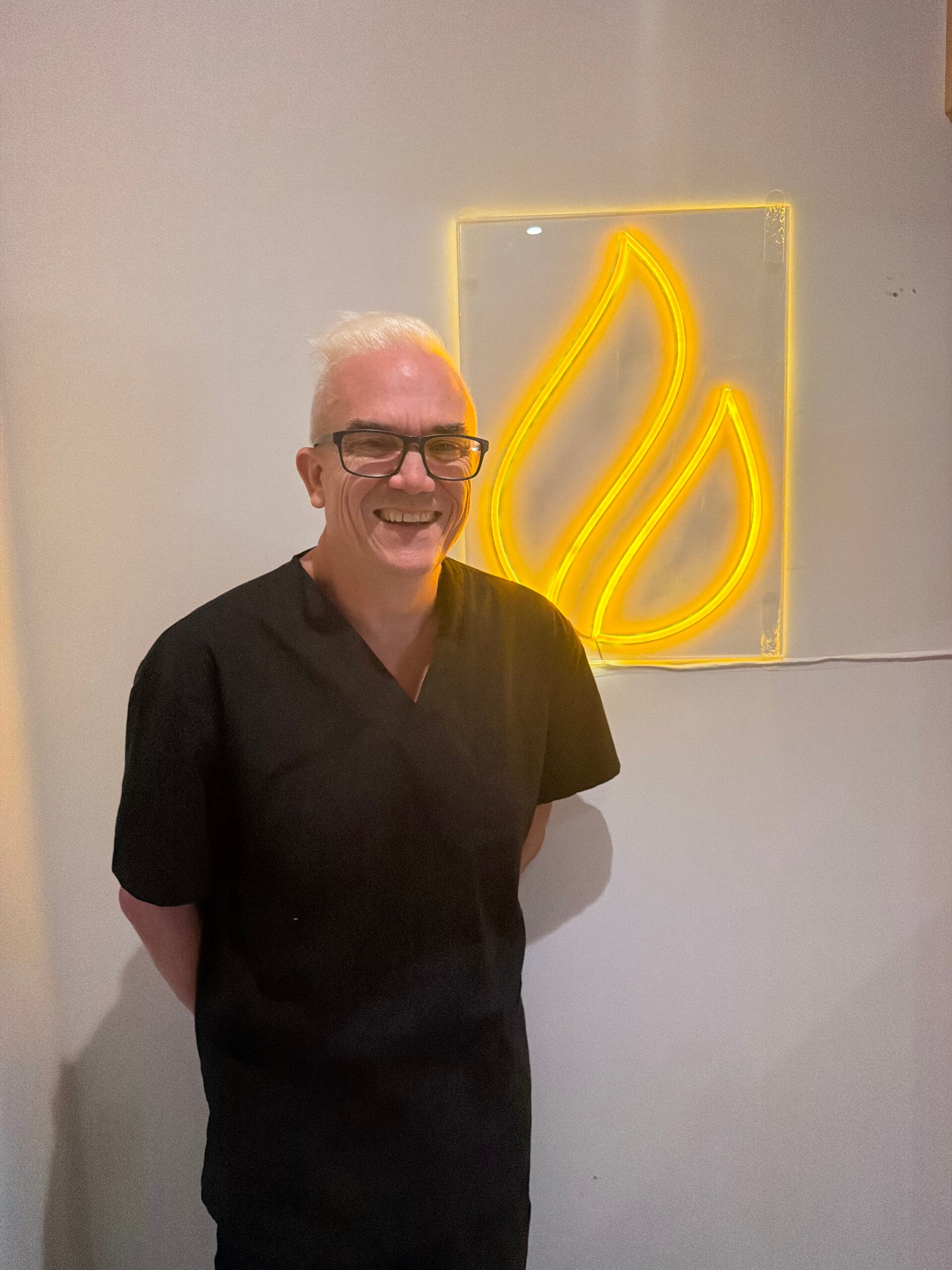 Corey Anderson RN welcoming a visitor inside the Core Aesthetics clinic in Oakleigh
