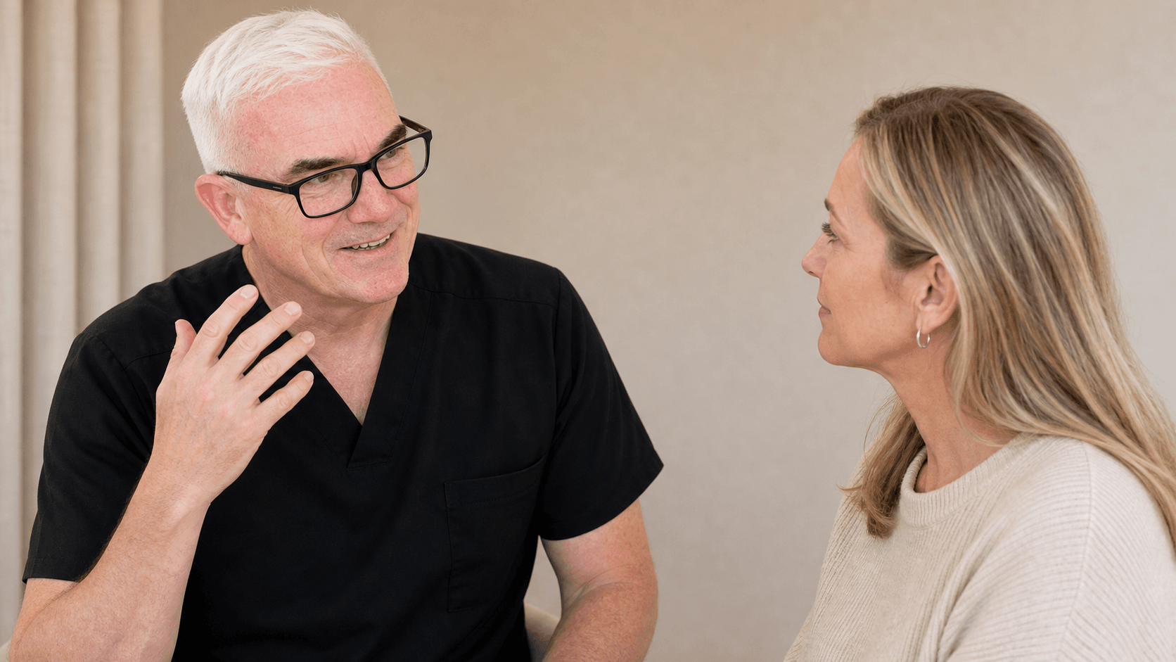 Corey Anderson RN listening to an adult patient during a whole-face consultation