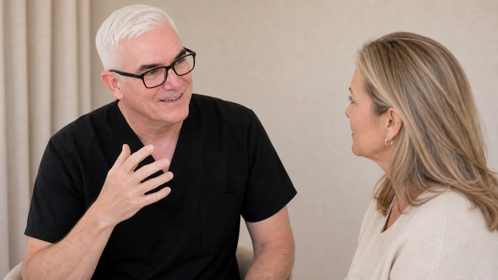 Corey Anderson RN listening to an adult woman during a facial support consultation