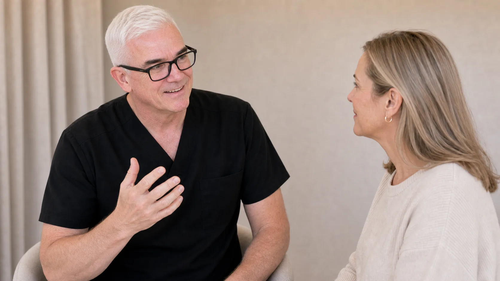 Corey Anderson RN and an adult woman considering the jawline, chin and neck transition during consultation