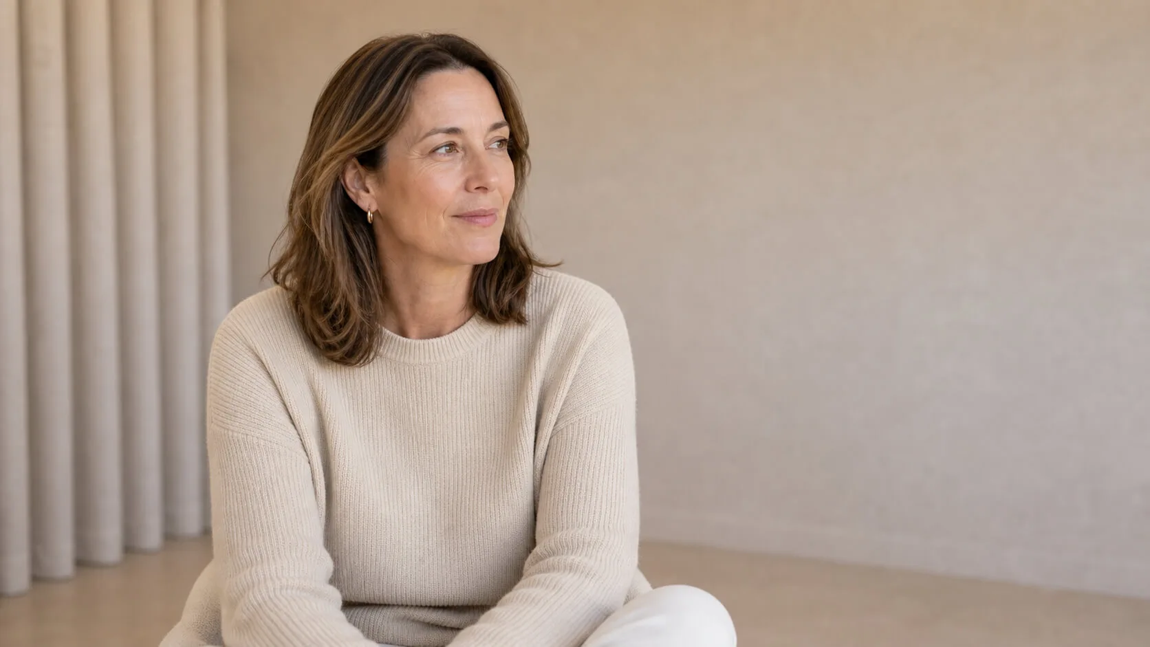 Adult woman in a welcoming clinic setting preparing questions for a cosmetic consultation