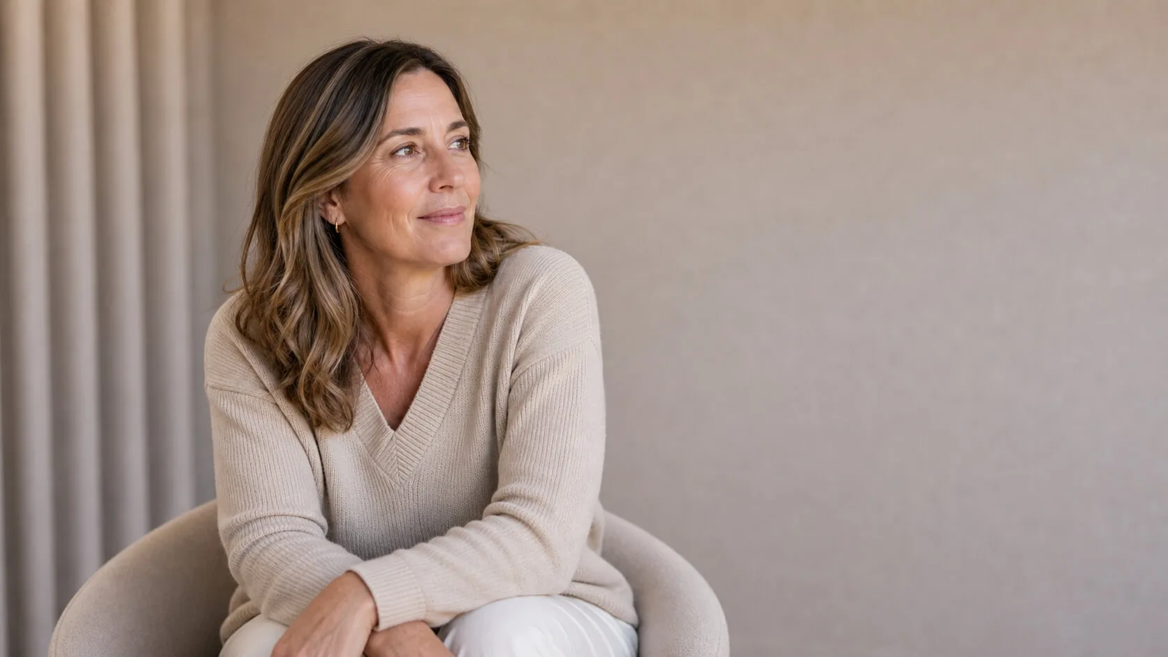 Adult woman in a calm clinic setting discussing cosmetic care questions