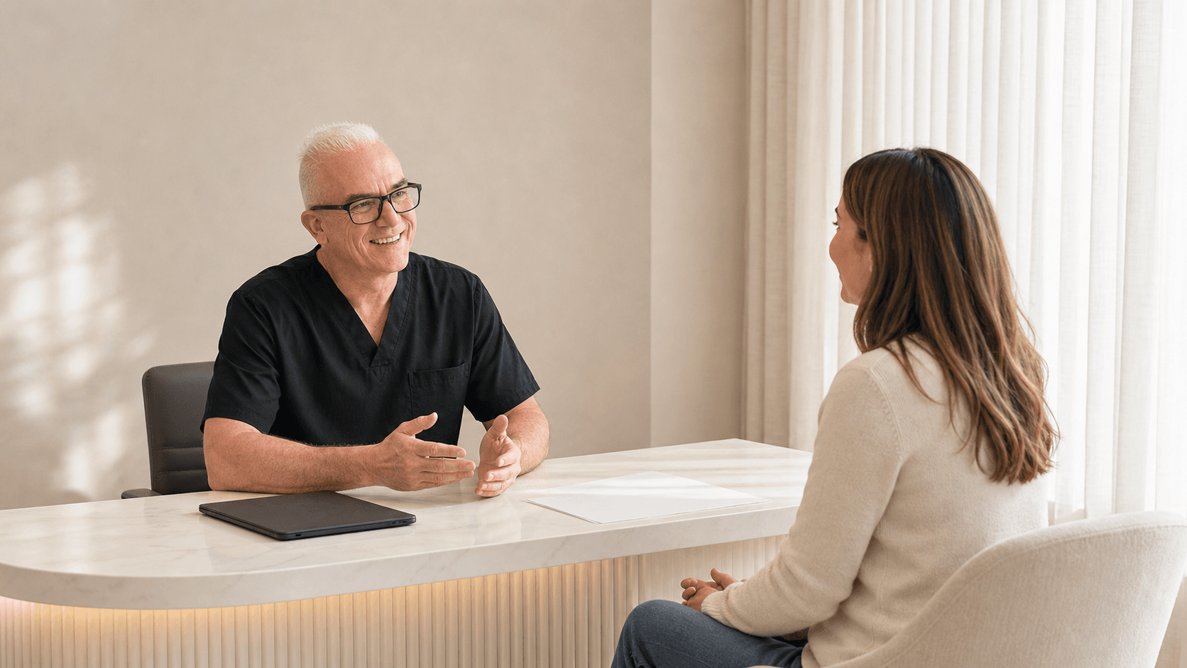 Corey Anderson RN discussing a treatment timeline and review questions with an adult patient