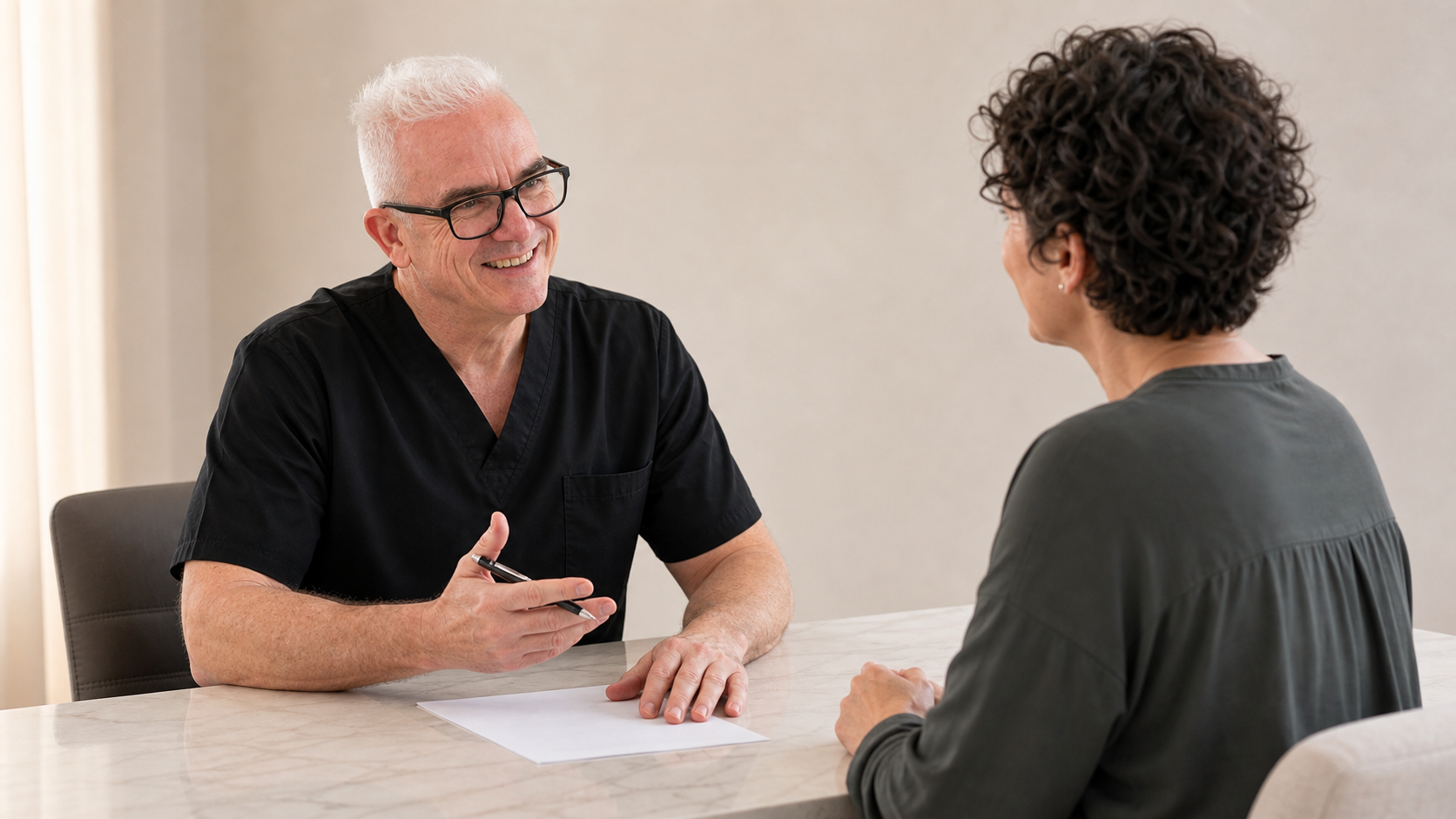 Adult woman and practitioner in a consultation setting discussing expectations and follow-up