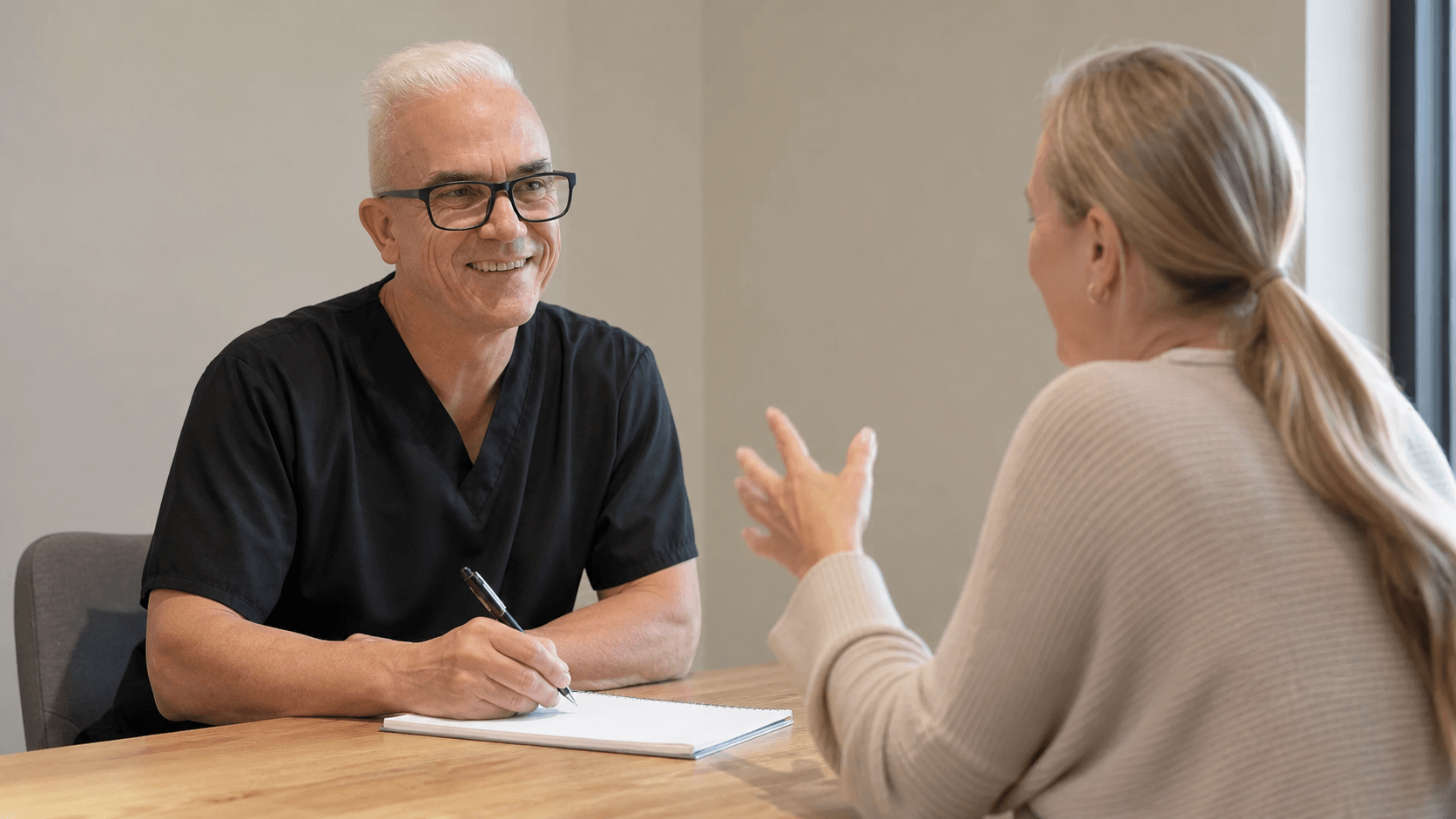 Corey Anderson RN speaking with an adult patient during a private consultation in Oakleigh