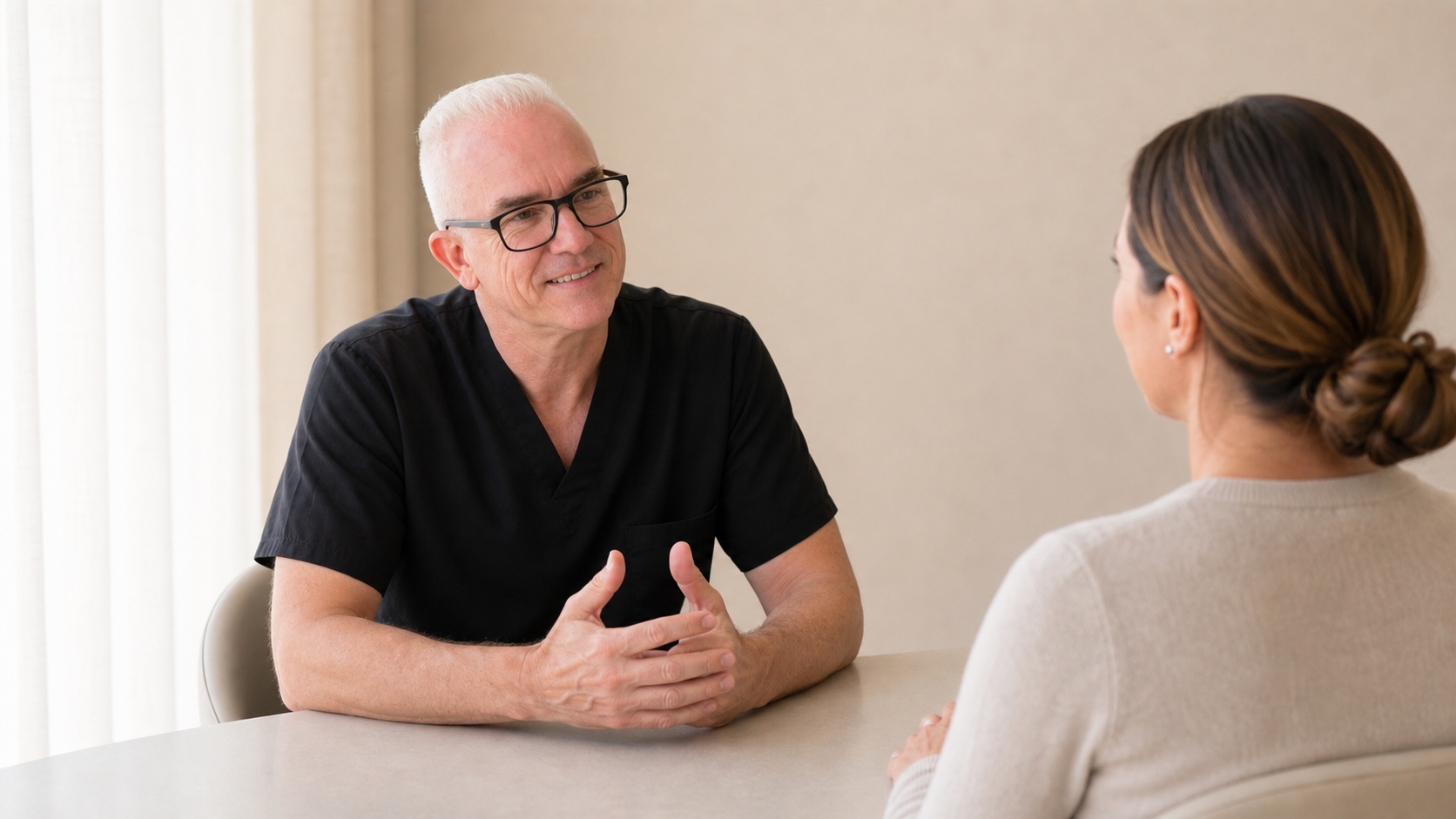 Corey Anderson RN discussing facial balance with adult patients in a consultation setting