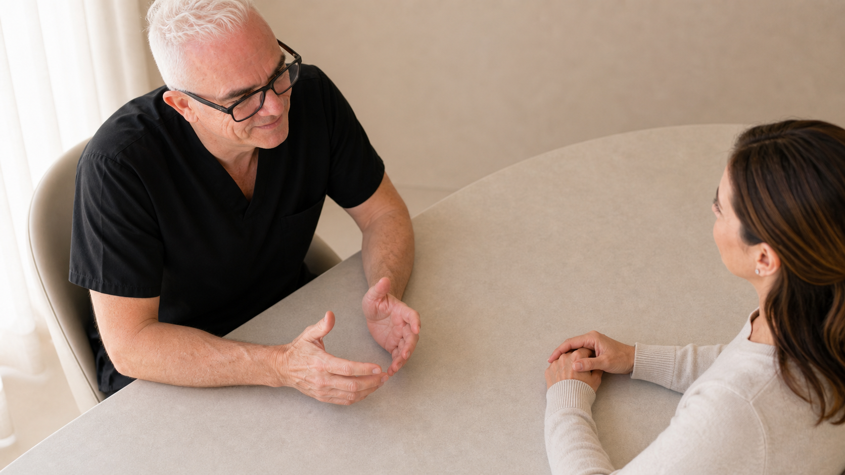 Two adults discussing facial assessment in a consultation setting