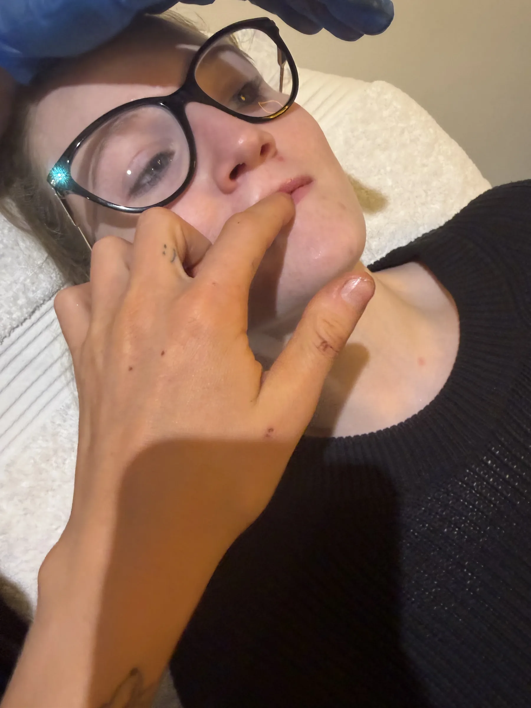Practitioner and adult patient discussing the mouth and lower face during consultation