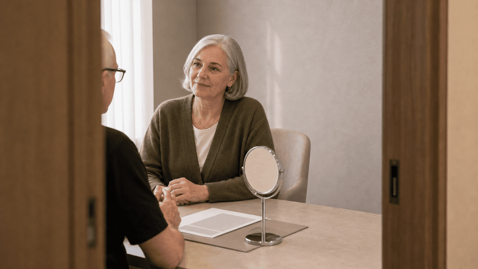 Corey Anderson RN listening to an adult patient preparing to discuss facial ageing concerns