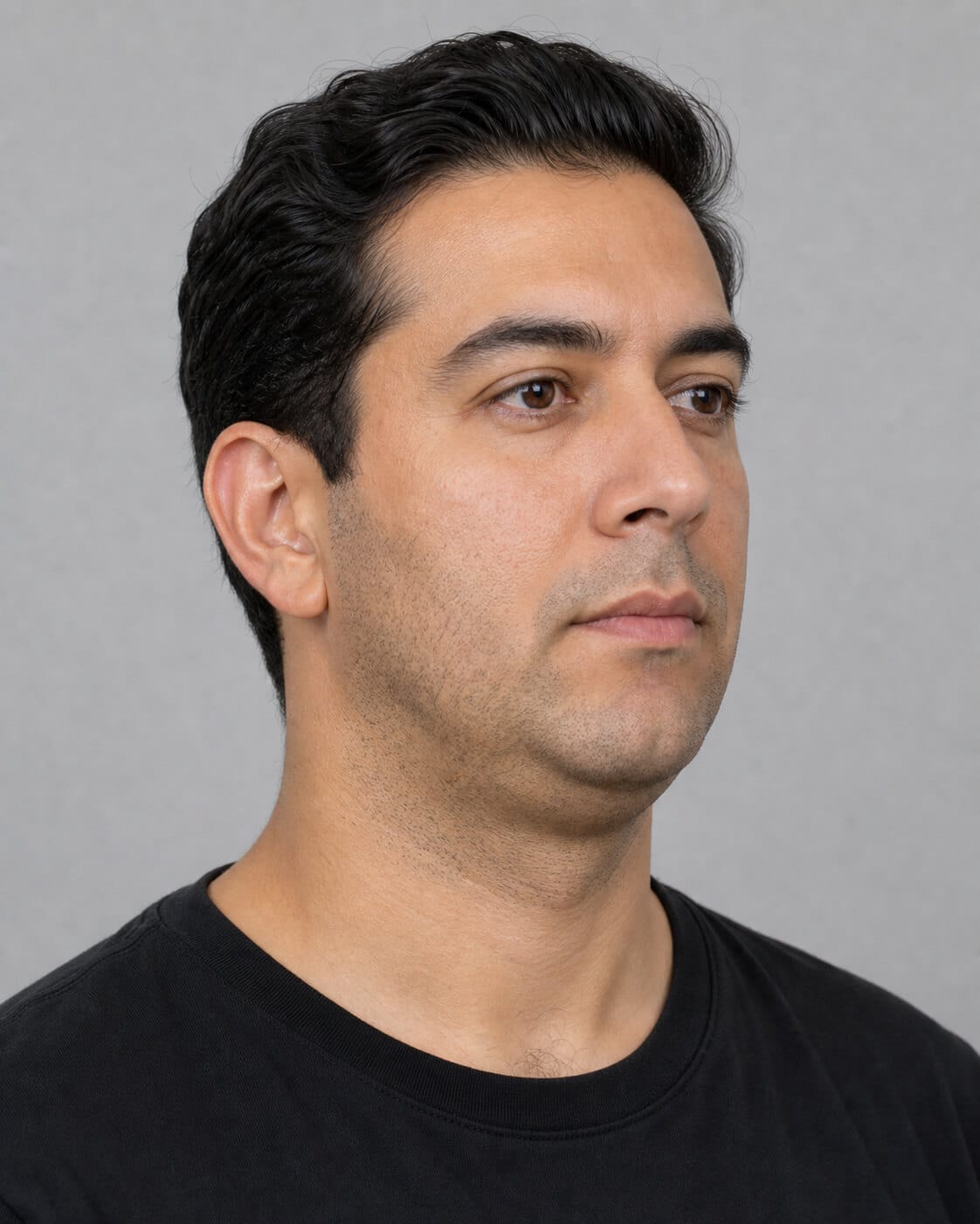 Adult man in three-quarter view used to discuss lower-face proportions during jaw muscle consultation planning