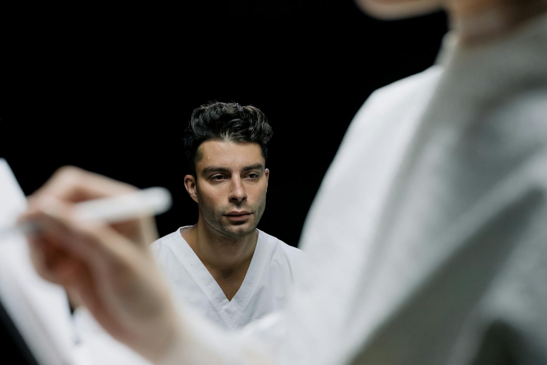 Man following a personal grooming routine in a bathroom setting.