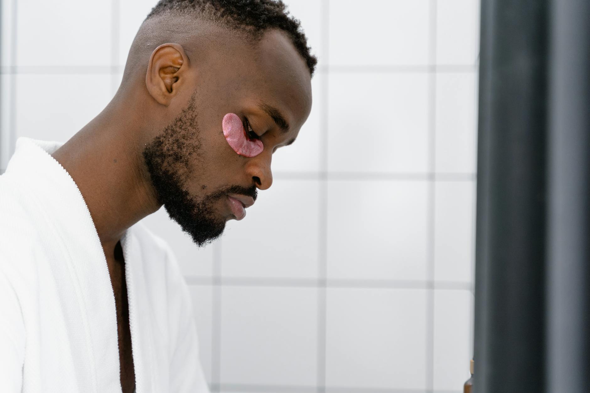 Man following a personal grooming routine in a bathroom setting.