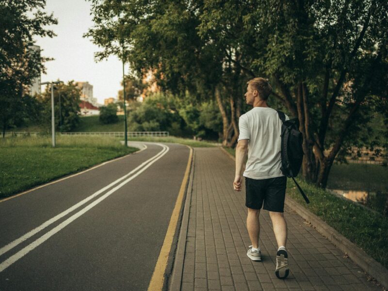 Man walking outdoors as part of a steady health routine