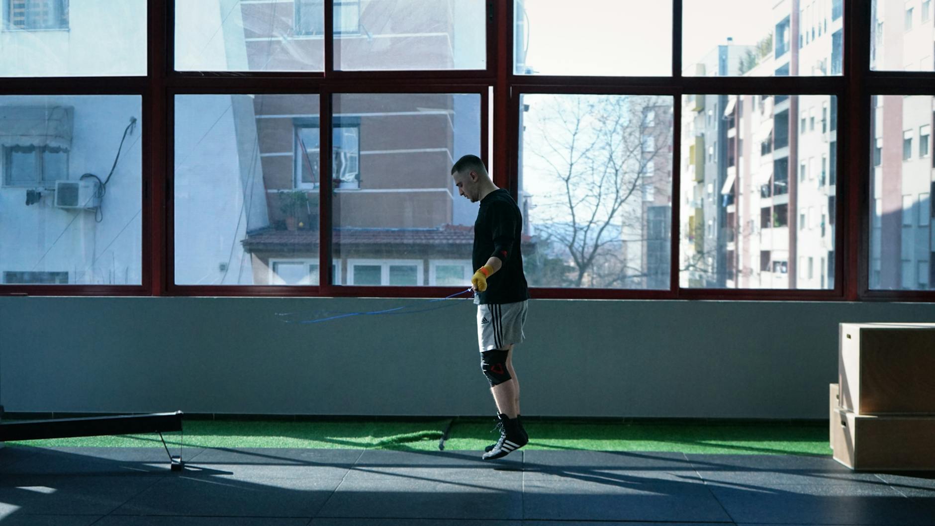 Man training with a skipping rope in a gym