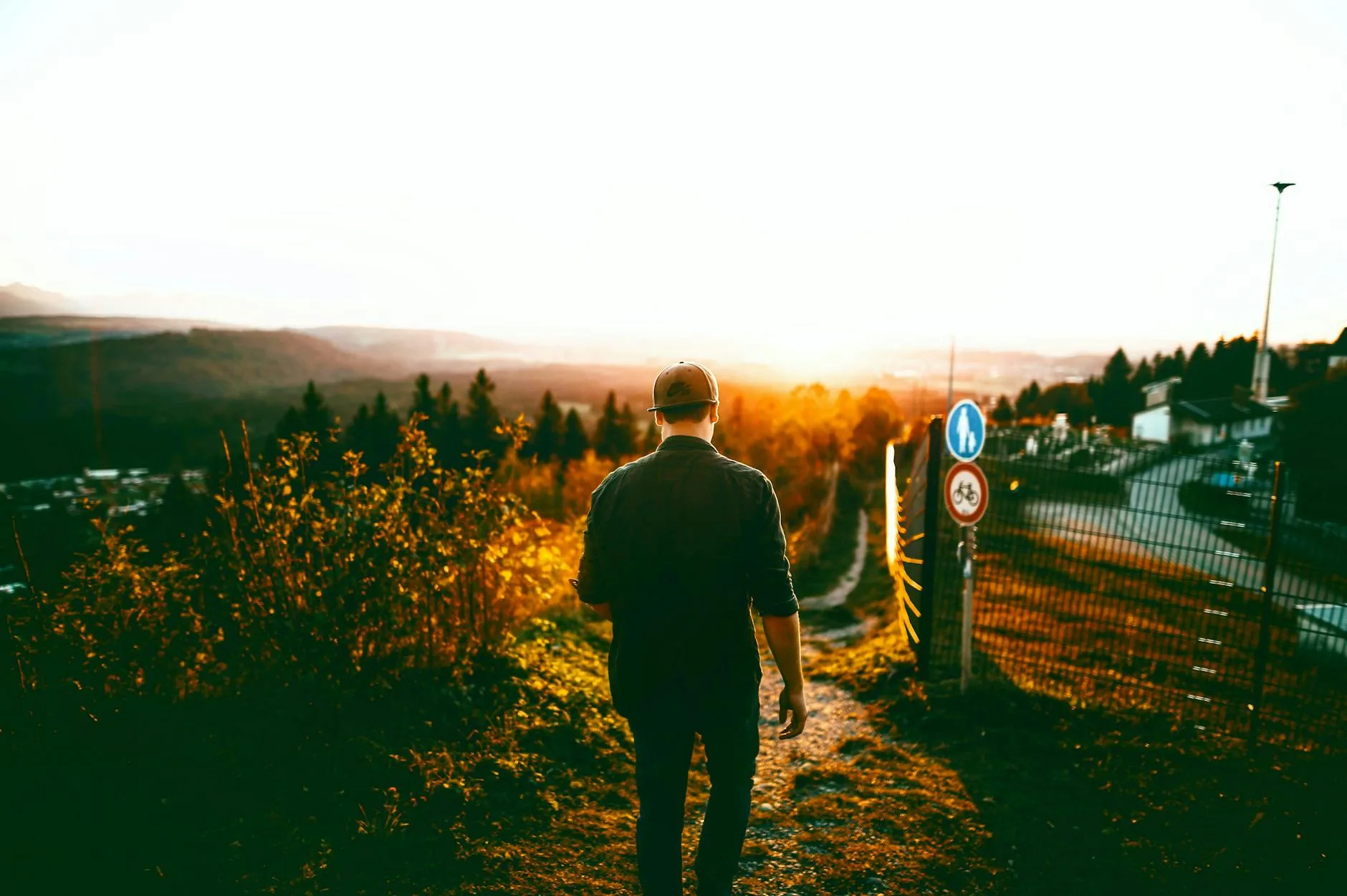 Adult walking outdoors at sunset.