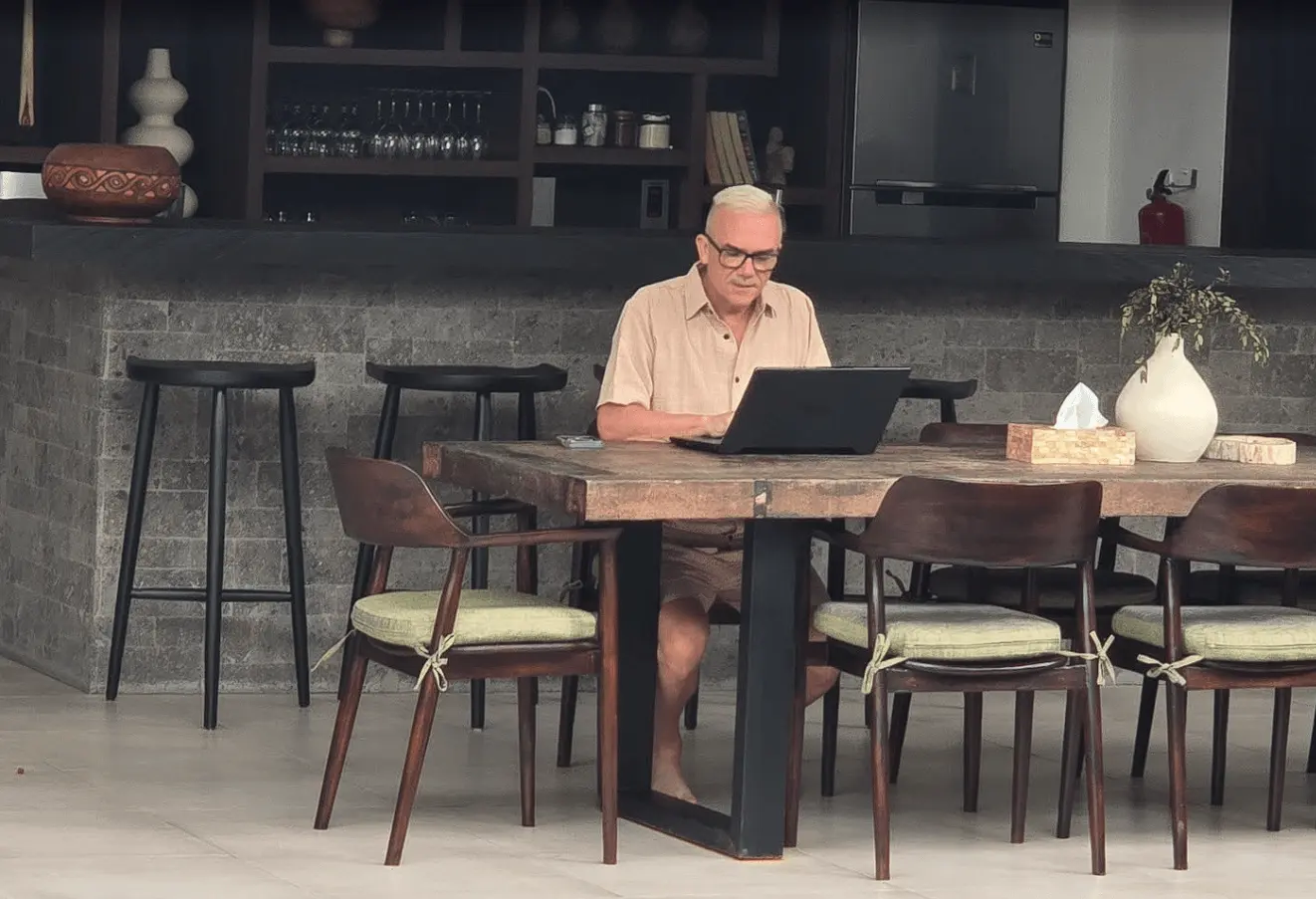 Corey Anderson reviewing appointment notes on a laptop at a long table